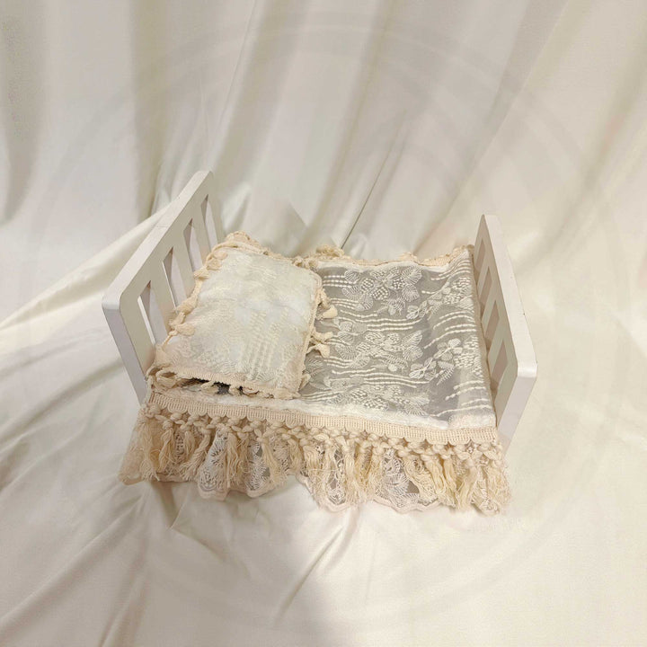 A 2-piece set featuring a newborn blanket and pillow with beige floral embroidery and tassel trim, perfect for newborn photography.