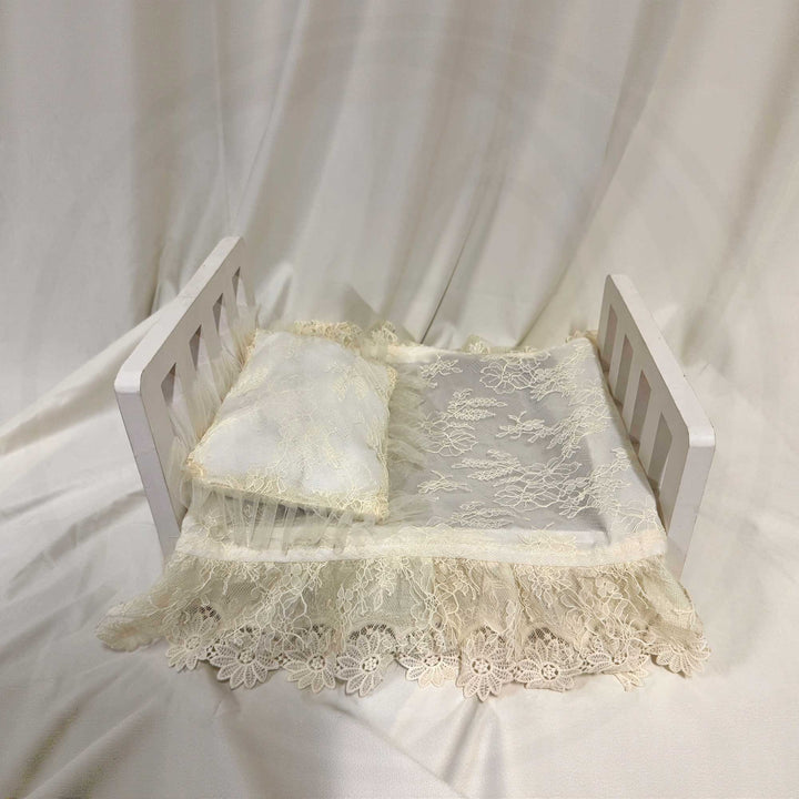 A 2-piece set featuring a newborn rug and pillow with beige lace ruffled tulle blanket and pillow set for newborn photogragphy props.