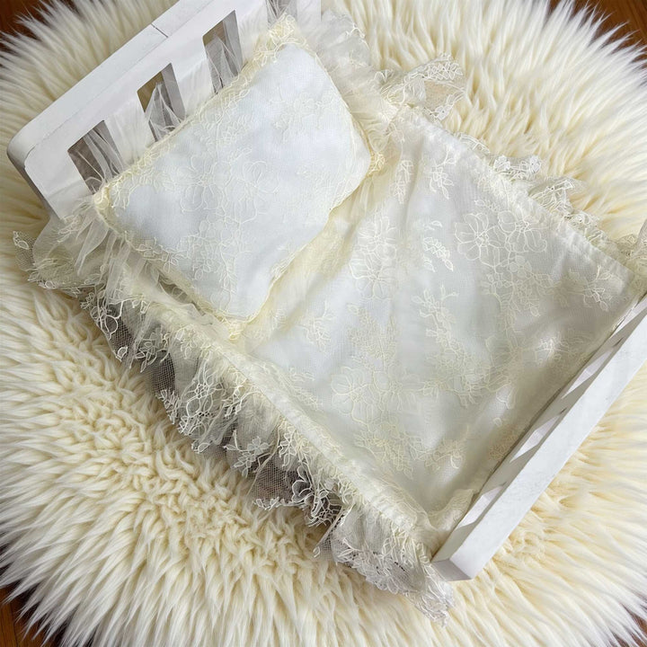 A 2-piece set featuring a newborn rug and pillow with beige lace ruffled tulle blanket and pillow set for newborn photogragphy props.