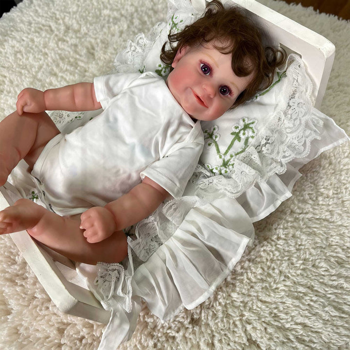 A 2-piece set featuring a newborn blanket and pillow with green floral embroidery and lace trim for newborn. photography.
