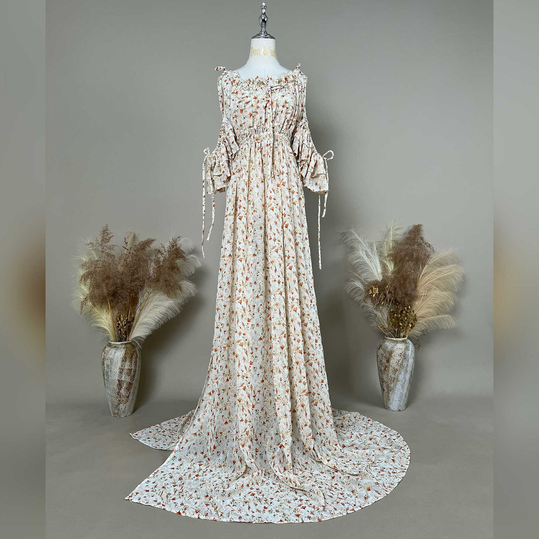 A mannequin displays an Alke floral off-shoulder gown with a train.