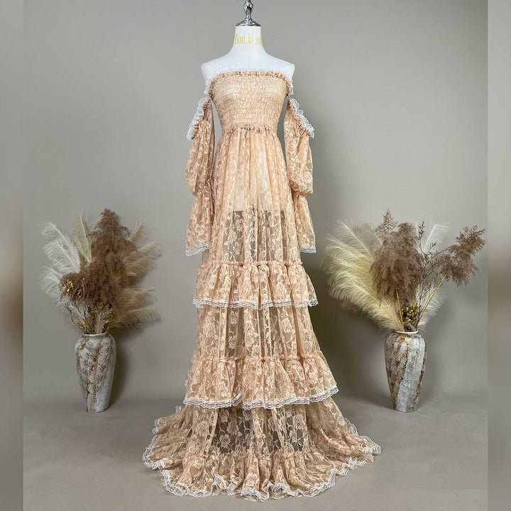 A Selene khaki lace off-shoulder unlined is displayed on a mannequin, featuring a shirred bodice, tiered ruffled sleeves, and a multi-layered cake skirt.