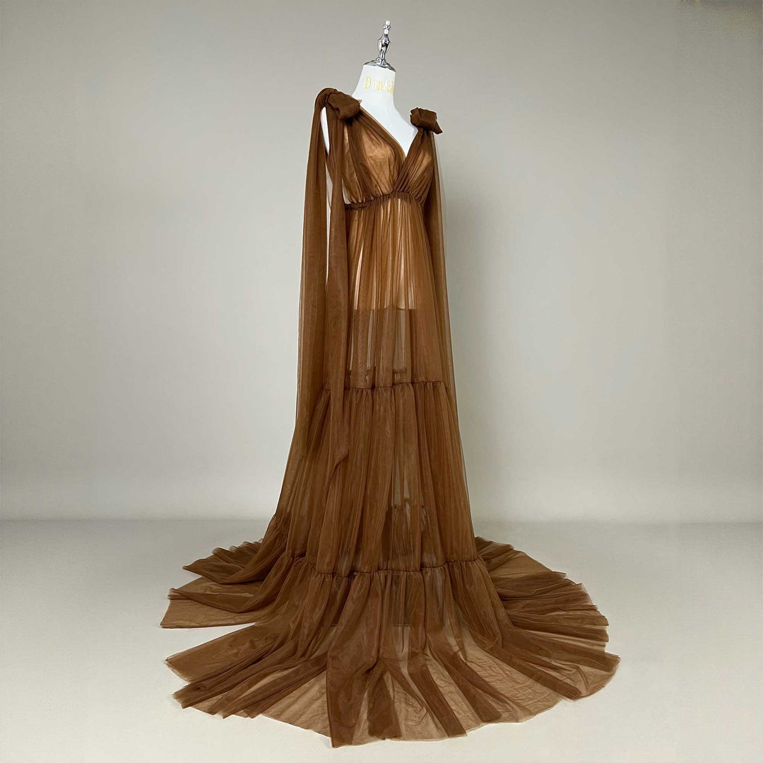 A side view of Acaste gown on a mannequin shows pleats and tiered structures; shoulder ties hang down.