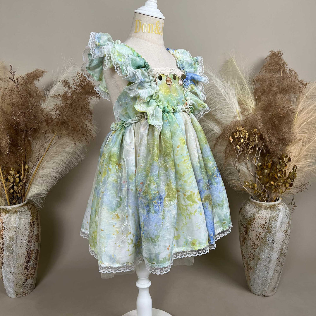 A side view of a mannequin displays an Adrasteia 3D floral lace trim dress. 