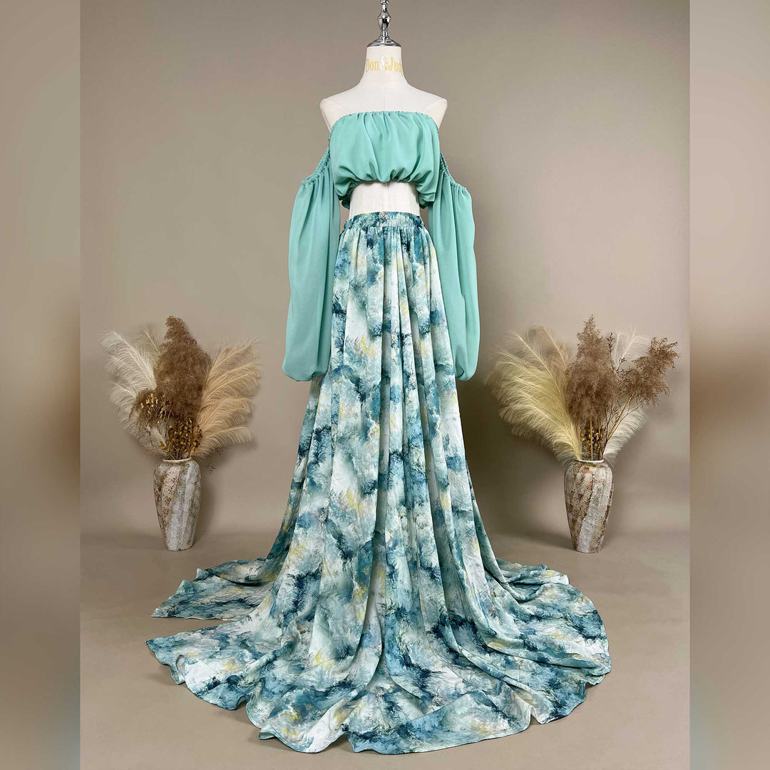 A Alala mint off shoulder top and a tie dye printed maxi skirt with a train are displayed on a mannequin. 