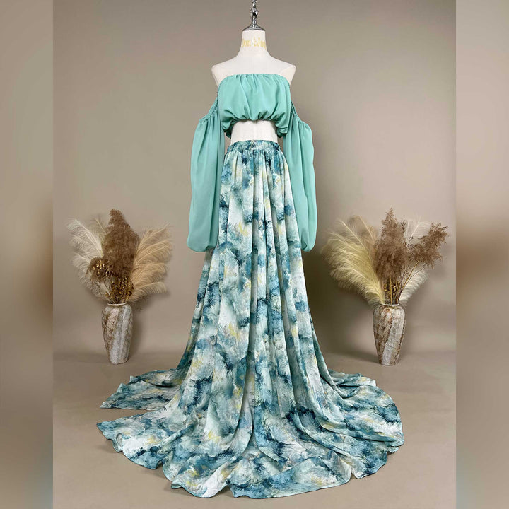 A Alala mint off shoulder top and a tie dye printed maxi skirt with a train are displayed on a mannequin. 