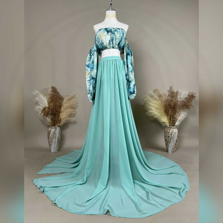 A Alala tie dye printed off shoulder top and a mint skirt with a train are displayed on a mannequin. 