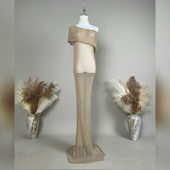 An Aletheia  camel sparkling off-shoulder gown is displayed on a mannequin.