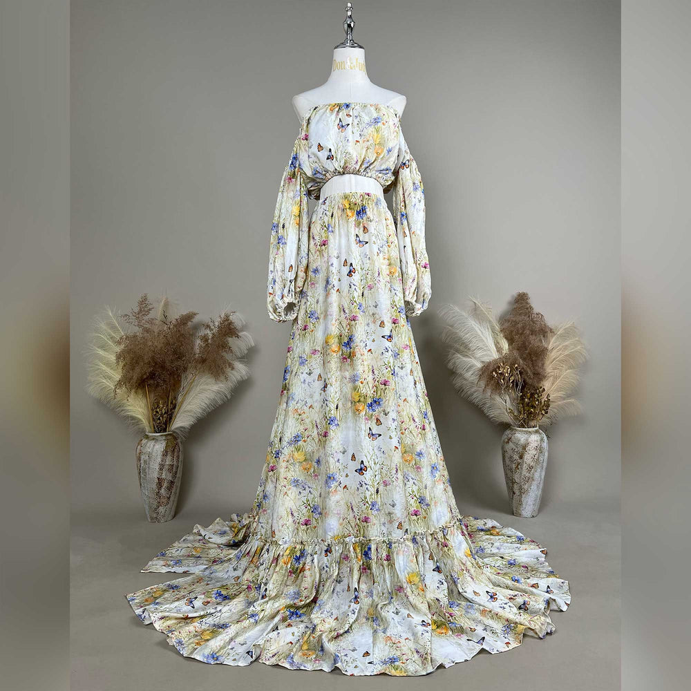 An Aphaea floral and butterfly print off-shoulder two-piece is displayed on a mannequin.