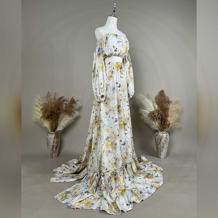 A side view of an Aphaea floral and butterfly print off-shoulder two-piece is displayed on a mannequin.
