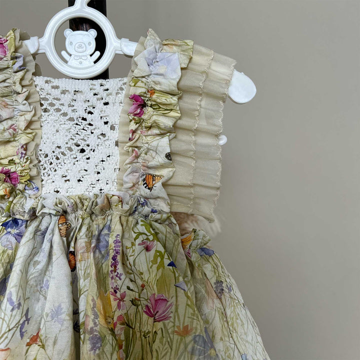 Close up of An Arachne floral tassel dress hangs on a mannequin.