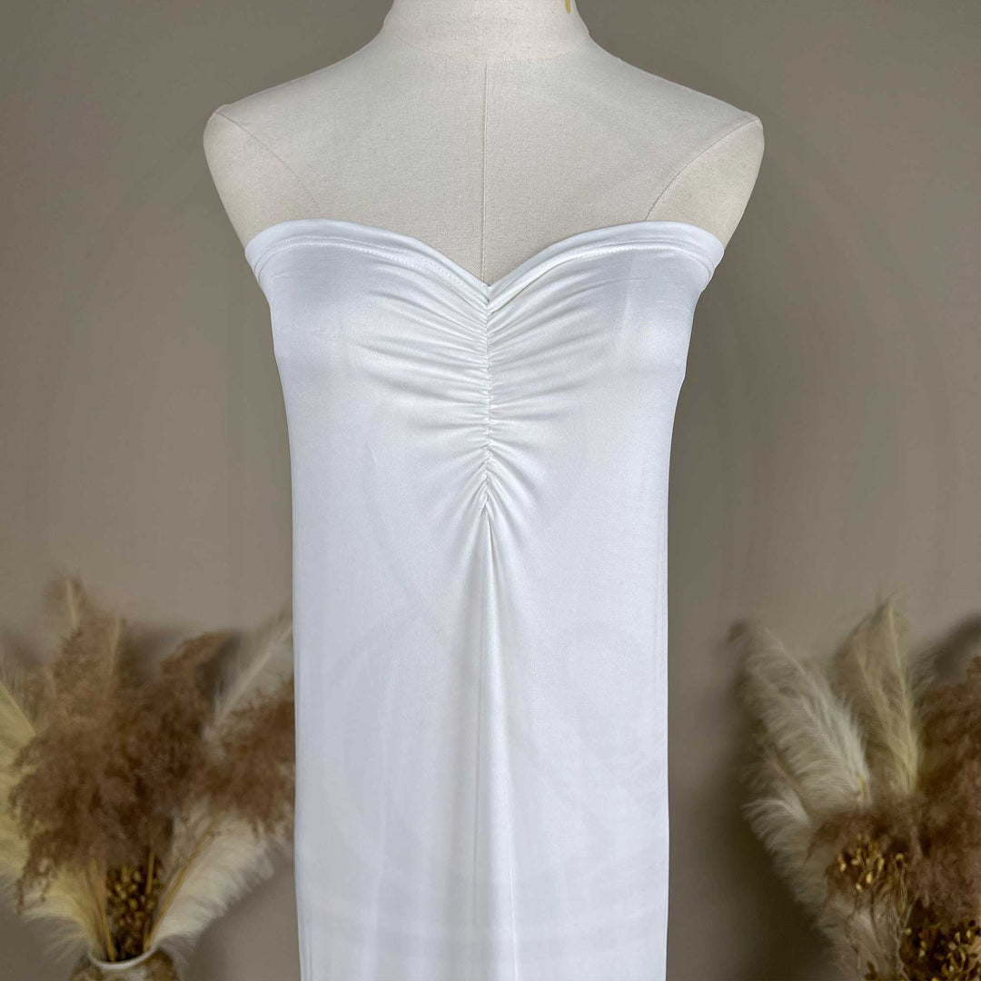 A close up of an Astraea satin maxi dress is displayed on a mannequin.