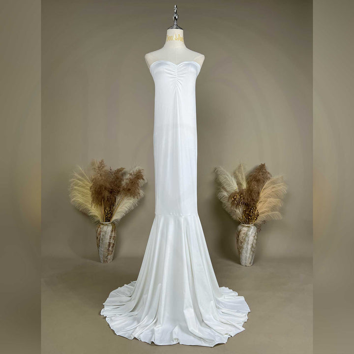 An Astraea satin maxi dress is displayed on a mannequin.