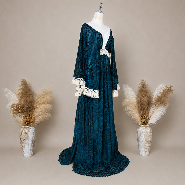 A Green,Bacche dress with a velvet cape and a white lace inner layer is displayed on a mannequin.