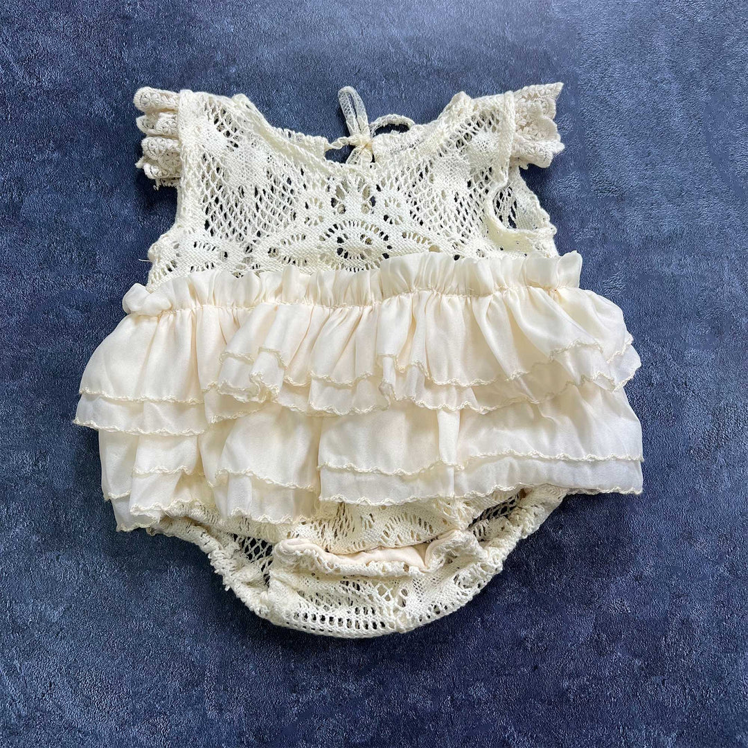 The upper part features crocheted openwork design with ruffled short sleeves.