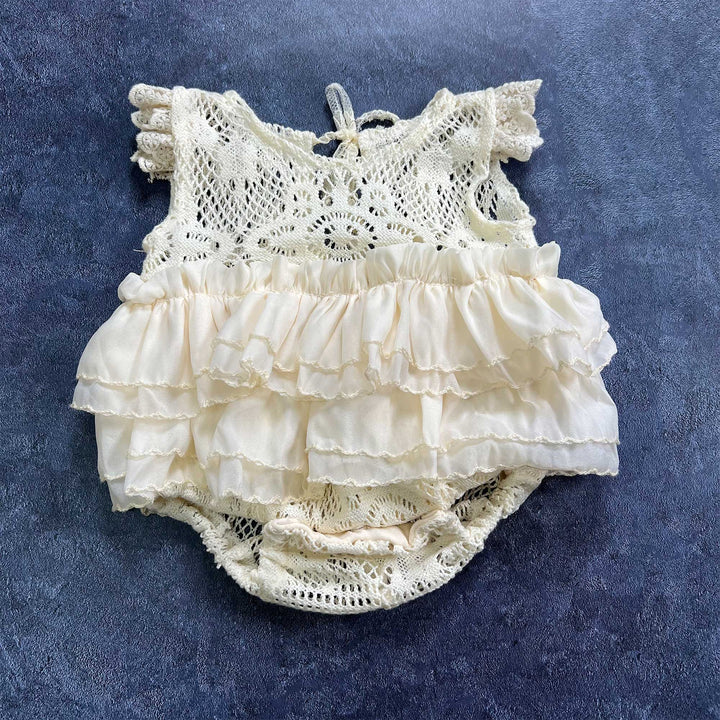 The upper part features crocheted openwork design with ruffled short sleeves.