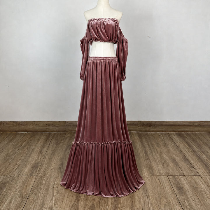 A KO-4,a Belisama velvet off-shoulder top and floor-length skirt are displayed on a mannequin. The two-piece outfit has a ruffled skirt hem.