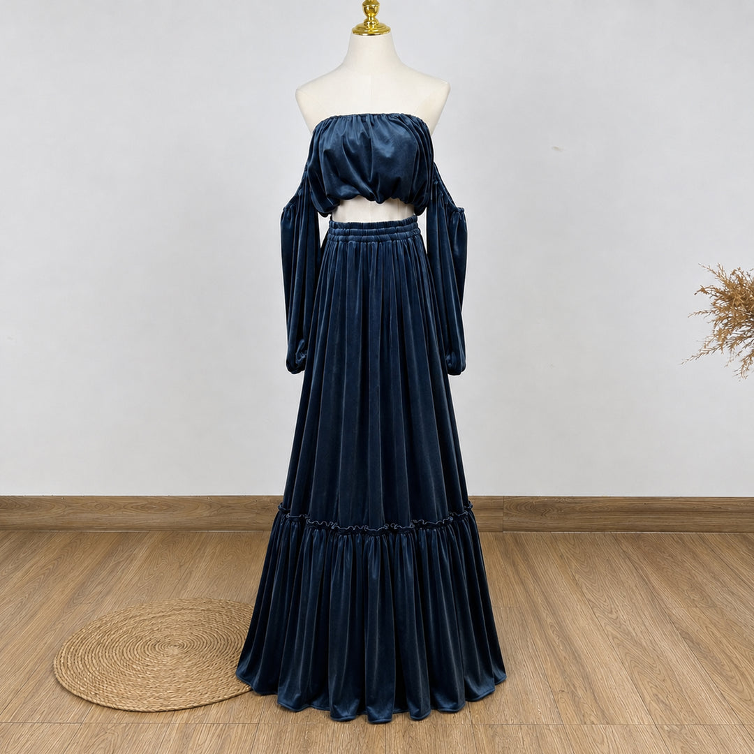 A KO-7,a Belisama velvet off-shoulder top and floor-length skirt are displayed on a mannequin. The two-piece outfit has a ruffled skirt hem.
