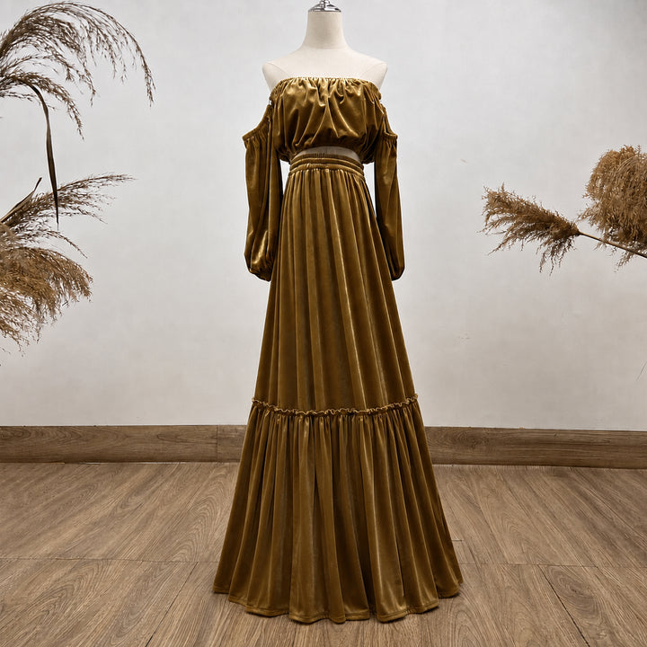 A KO-9,a Belisama velvet off-shoulder top and floor-length skirt are displayed on a mannequin. The two-piece outfit has a ruffled skirt hem.