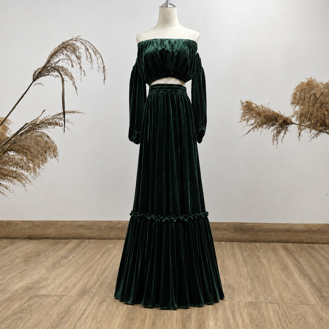 A KO-12,a Belisama velvet off-shoulder top and floor-length skirt are displayed on a mannequin. The two-piece outfit has a ruffled skirt hem.