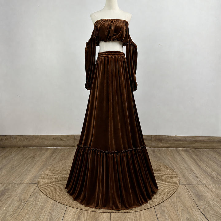 A KO-15,a Belisama velvet off-shoulder top and floor-length skirt are displayed on a mannequin. The two-piece outfit has a ruffled skirt hem.