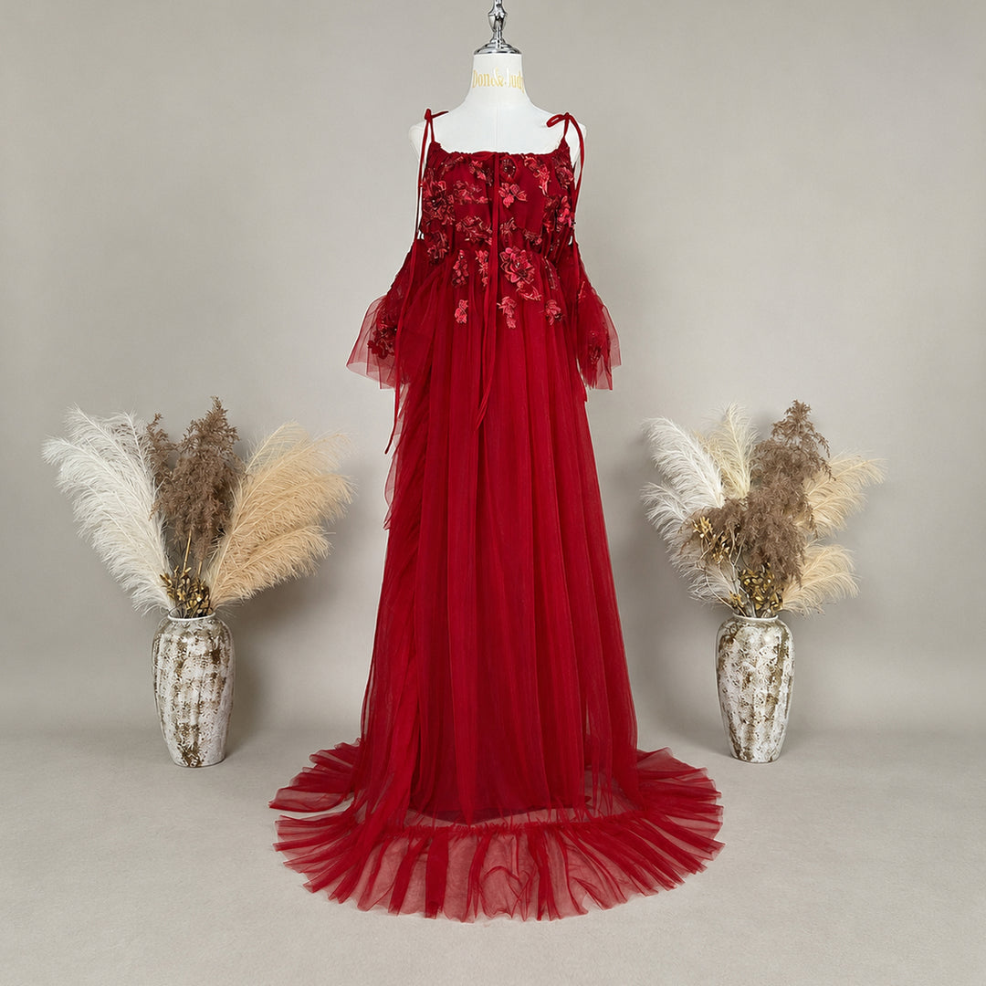 A red embroidered strapless tulle gown is displayed on a mannequin