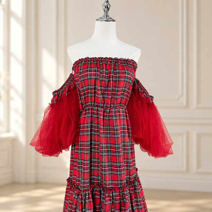 a bodice close-up of the Celaeno plaid dress, showing the smocked off-shoulder neckline, waist smocking and tulle sleeves on both sides.