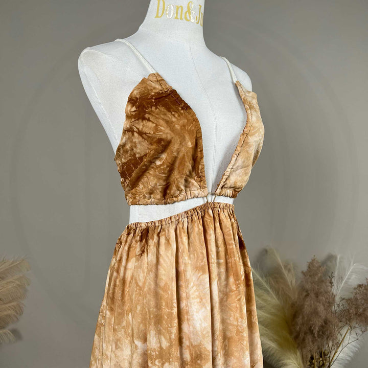 A close up of Demeter tie dye printed spaghetti straps two-piece gown with a deep V-neck and train is displayed on a mannequin. 