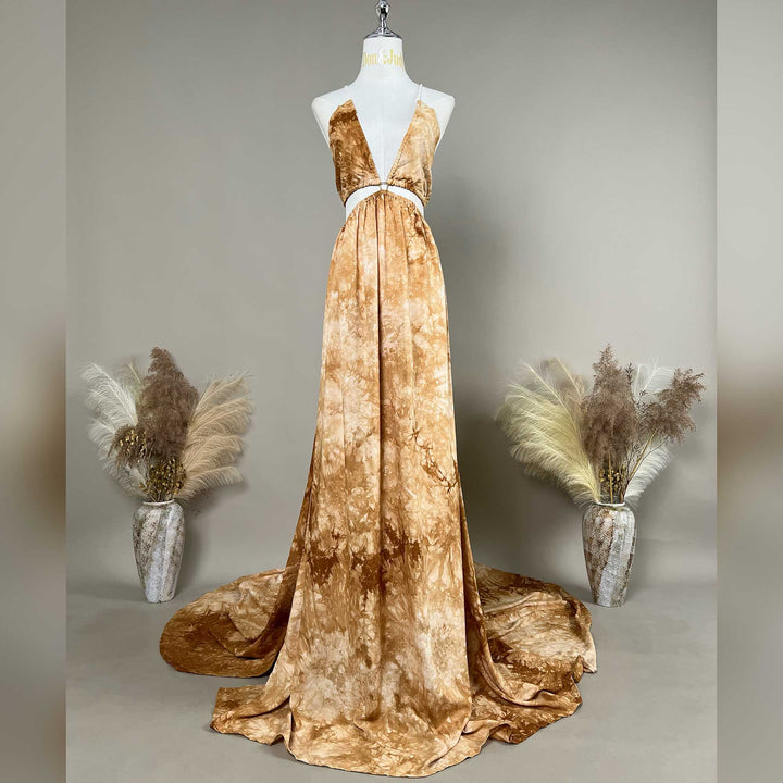 A Demeter tie dye printed spaghetti straps two-piece gown with a deep V-neck and train is displayed on a mannequin. 