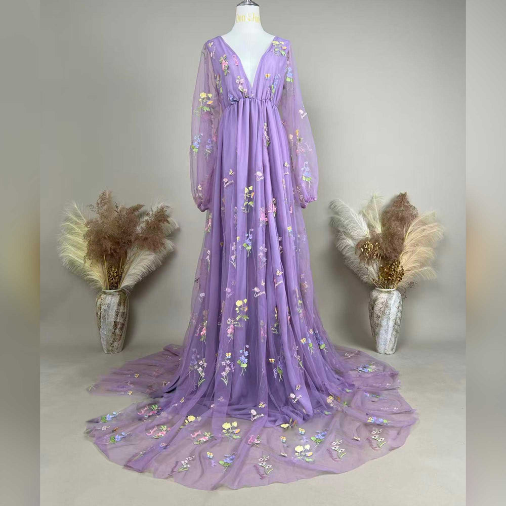 A Dike purple tulle long-sleeve floral embroidered gown with a train is displayed on a mannequin.