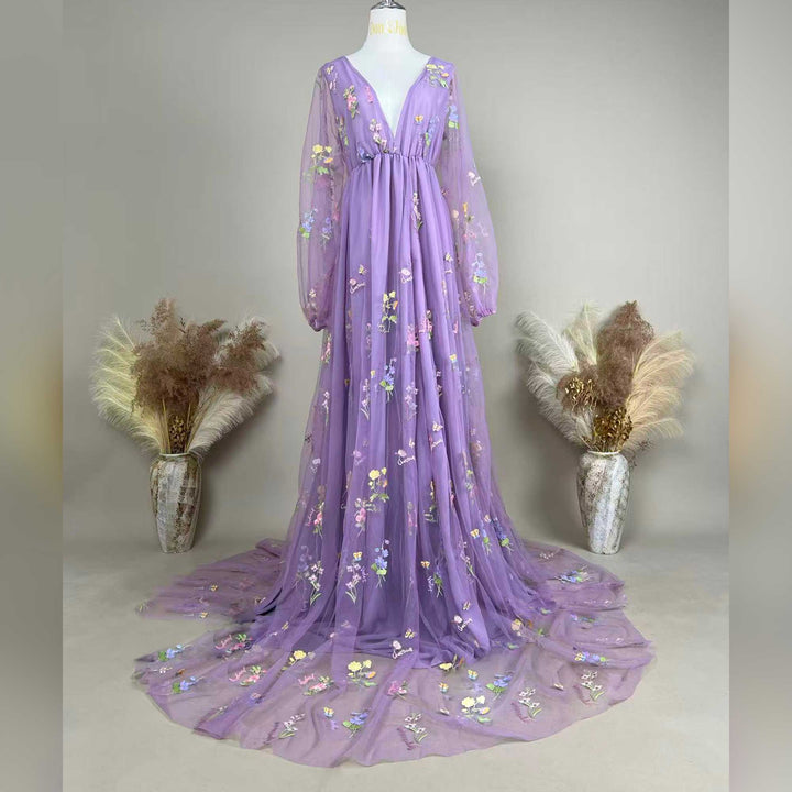 A Dike purple tulle long-sleeve floral embroidered gown with a train is displayed on a mannequin.