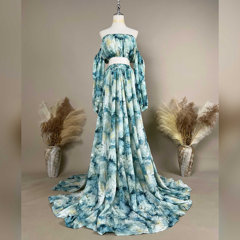 A Hestia tie dye print off-shoulder top and long skirt with a train are displayed on a mannequin. 