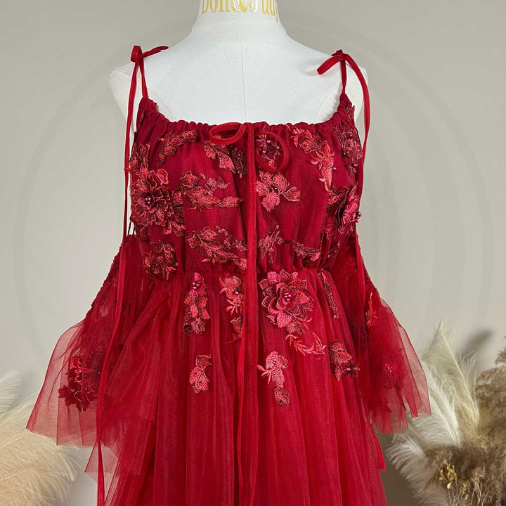 Close-up detail of the Red floral embroidered off-shoulder tiered ruffle maternity photography dress.