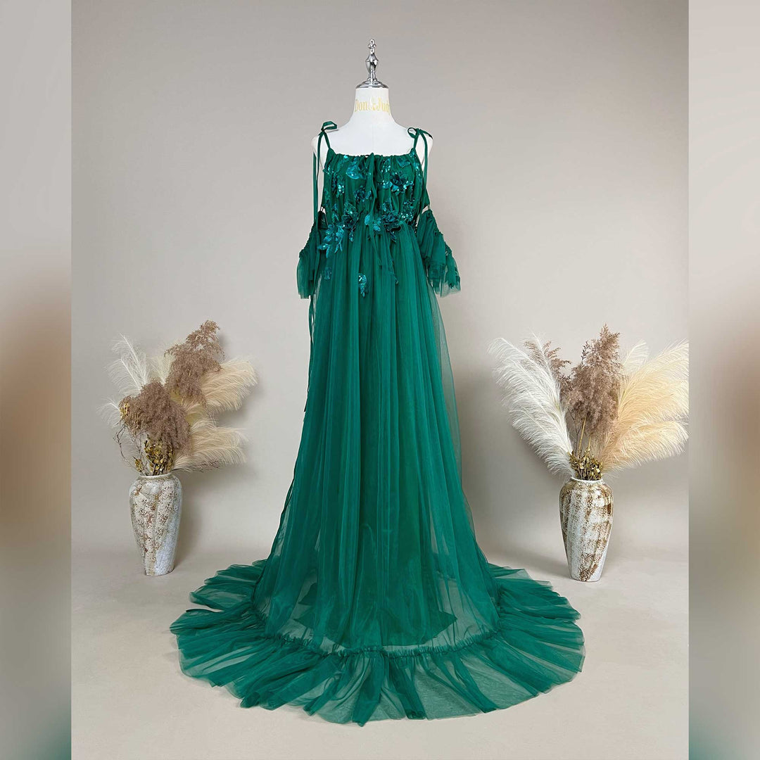A Oreades green floral embroidered off-shoulder tiered ruffle maternity photography dress on a mannequin.