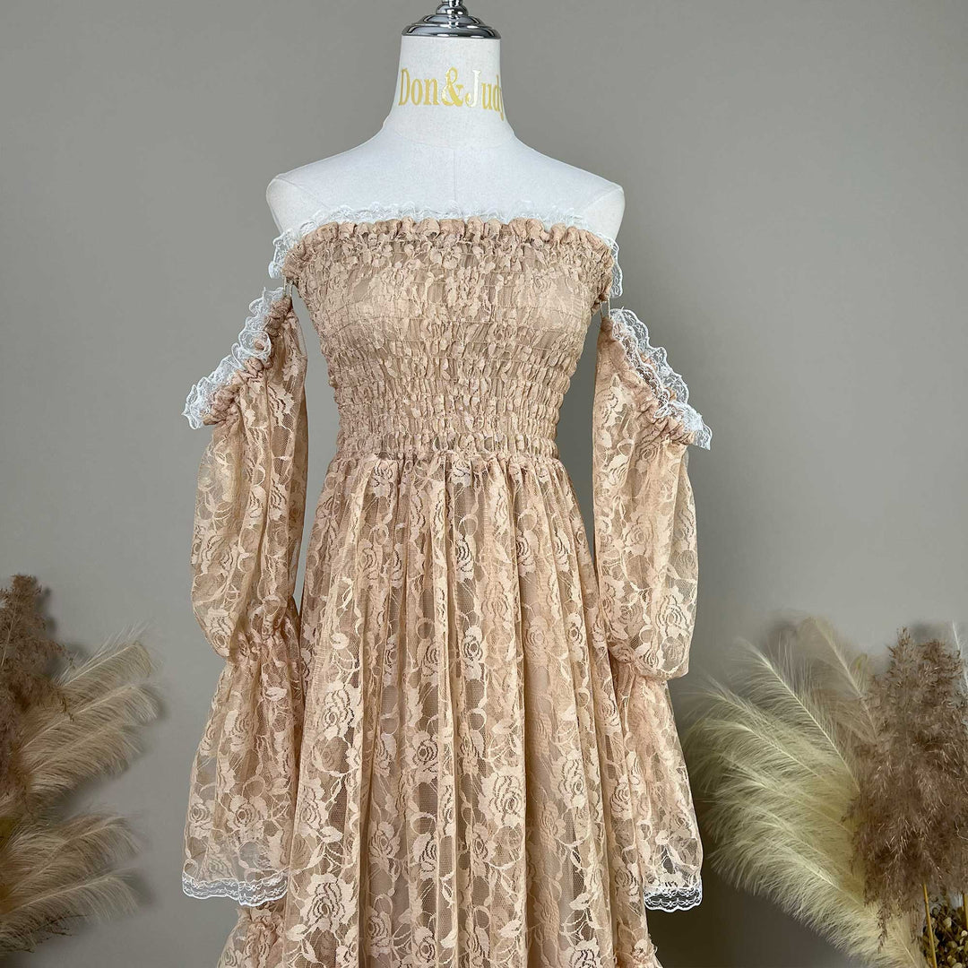 This khaki Selene lace gown is displayed on a mannequin, featuring white lace trim on the sleeves and skirt. 