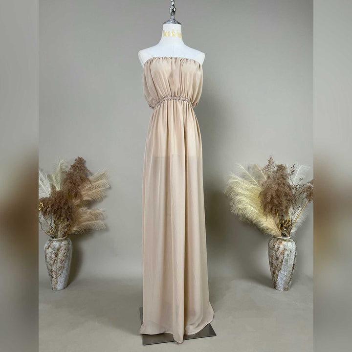 A khaki strapless chiffon gown is displayed on a mannequin.