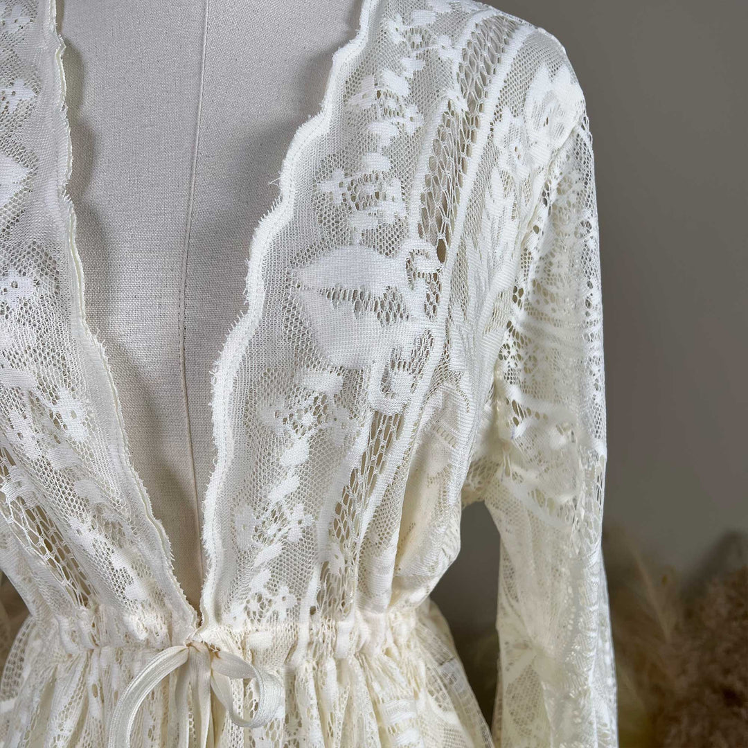 A beige lace ,Zephyra dress with intricate lace patterns throughout.
