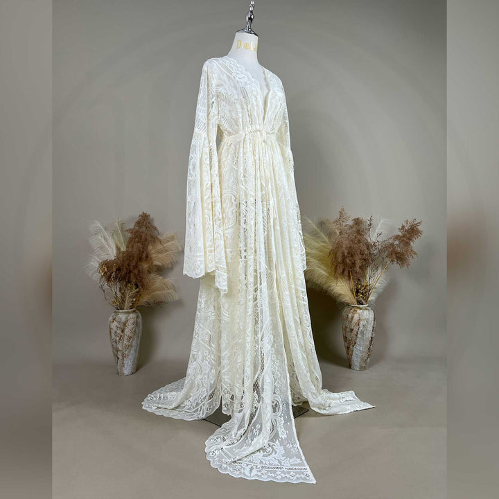 A beige lace ,Zephyra dress with long bell sleeves and a V-neckline, displayed on a mannequin. 